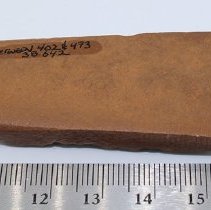 Bottom side of basalt adze and ruler