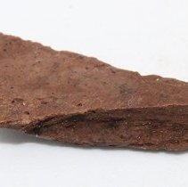 Closeup lengthwise view of a fish hook tab made of worked bone