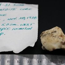 Quartzite core with artifact slip and ruler