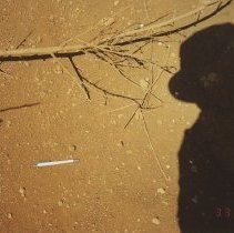 Erosion cut under a brush pile with writing pen