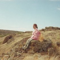 Unidentified person sitting on a pohaku