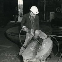 Esco foundry worker using power tool