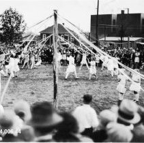 Onlookers Observe a May Pole Dance