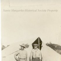 2 men in front of tent