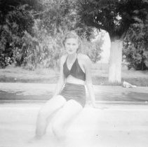 Unnamed woman by swimming pool