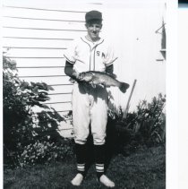 Tom Brown with fish in baseball uniform
