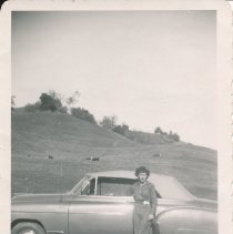 Beckie Epperly standing with Johnnie's (Epperly) 1950 car.