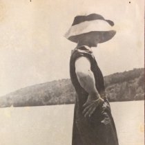 Woman on Dock in Bathing Costume & Large Sun Hat.