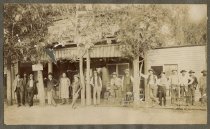 [Group on sidewalk outside stores, Hawthorne, circa 1905]