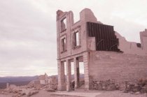 dilapidated multi-story stone structure, bank building