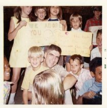 Color,  3.5x3.5. March 1973. "Commander Stratton, a returned POW, is the center of attention."