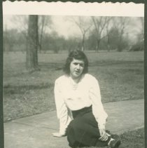 Cornelia Alexander Elmore sitting on a sidewalk