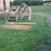 A.P. Elmore pushing Matt Elmore on a bicycle