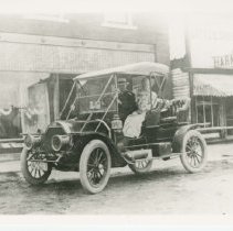 (73) 1910s Auburn in front of Little Shoe's Store, Man Driver, Woman Passen