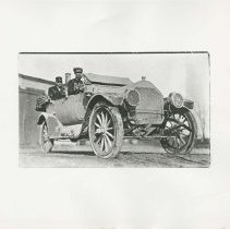 (75) 1911 Auburn 3/4 Front Right View, Two Men in Car