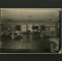 (897A)Man in an Auburn Dealer with Several Autos in the Shot