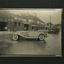 (897C) Two Men in an Auburn Outside an Auburn Dealer,Lincoln Repair Service