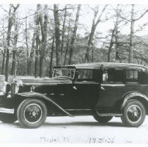 (941) 1931 Checker Model M, 3/4 Front Right Profile, Wooden Area Behind