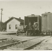 (380) Loaded Automobiles at the Railroad Siding with Two Men