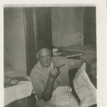 (586) Auburn Barber and Restaurateur Thomas Proctor with a Newspaper