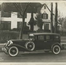 (125) 1929 Cord L-29 Sedan, left profile, at extravagant house