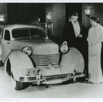 (414) 1936 Cord 810 Prototype, man touching the headlights, woman beside