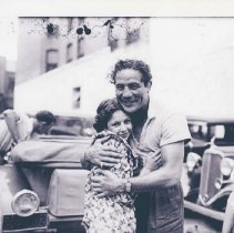 (141)1930 Duesenberg J Convertible and boxer Max Baer hugging woman