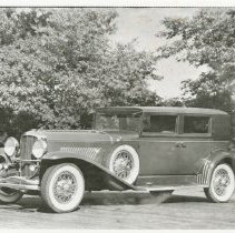 (313) 1930 Duesenberg Beverly Berline, 3/4 front left profile, trees behind