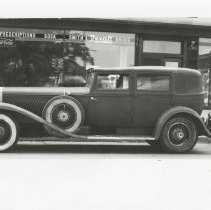 (317)1930 Duesenberg J-452 Car2470 Berline in front of Smith's Rexall Drugs