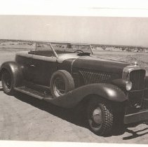 (422)1931 Duesenberg J Coupe, 3/4 front right view, in a beach setting