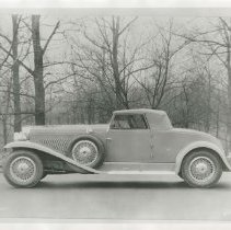 (499)1930 Duesenberg J Convertible Coupe, left profile, woods behind