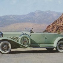 (533)Postcard of 1931 Duesenberg J Convertible Coupe, mountains in Reno, NV