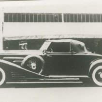 (570)1929 Duesenberg J Convertible Coupe in front of parking garage