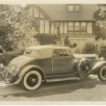 (1077)1929 Duesenberg J Dual Cowl Phaeton in driveway of a house