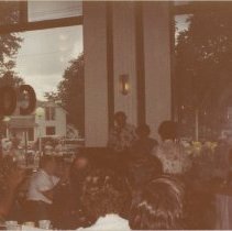 An unidentified person in a patterned shirt at podium in ACD Museum