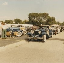 Auburns and Cord automobiles in the parking lot and street in front of the ACD Museum
