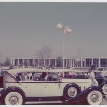 Packard automobile in the forefront at a classic car meet