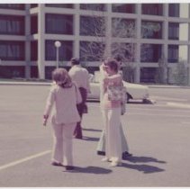 Five unidentified well-dressed people in a Parking lot
