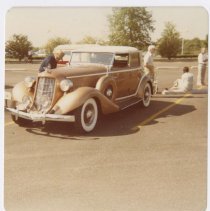 1935 Auburn 851 convertible phaeton in a parking lot with spectators around