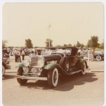 1930s Cadillac with people in the photo at a car show in a parking lot