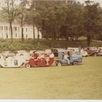 Kids "train ride," in front of Cords and Auburns and a white house on Lawn