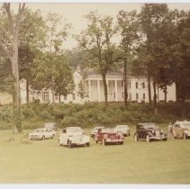 Auburn and Cords in front of a white house on Lawn