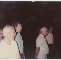Group of five unidentified people in the dark