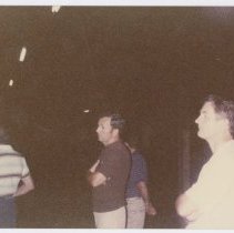 Group of 4 unidentified men in a dark area