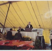 Kruse auction tent selling a Ford Thunderbird with its hood ajar