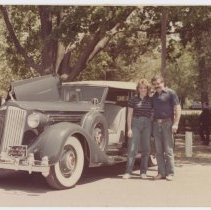 Jack Randinelli and Ruth Randinelli by grey Packard with Plaque