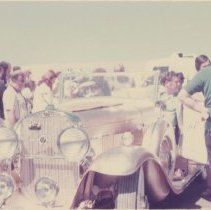 Festival goers around a Cadillac V-8