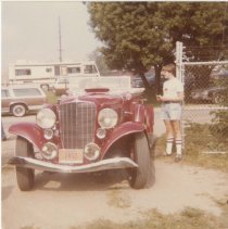 Kid standing by a 1933 Auburn