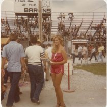 Woman in pink romper handing out flyers