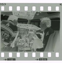 Filmstrip of two unidentified men in an airplane cockpit